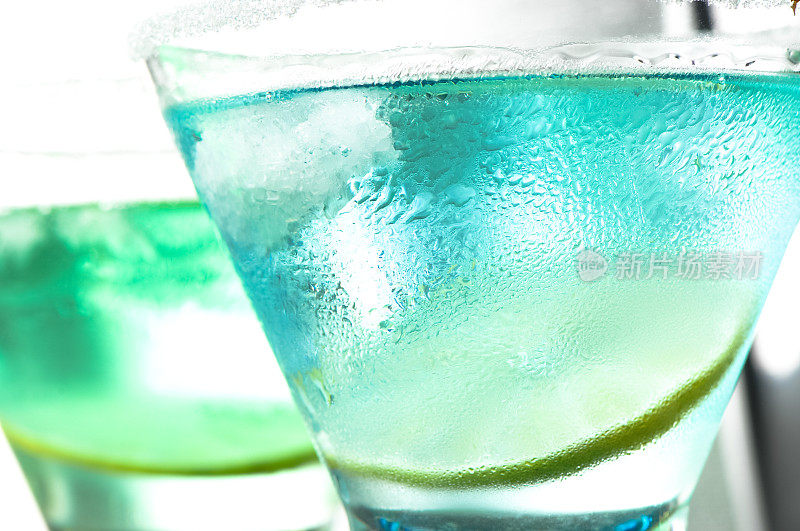 蓝绿色鸡尾酒在明亮的酒吧