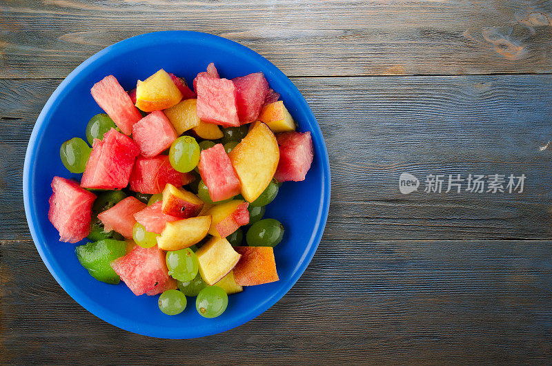蔬菜沙拉和水果放在一个盘子里