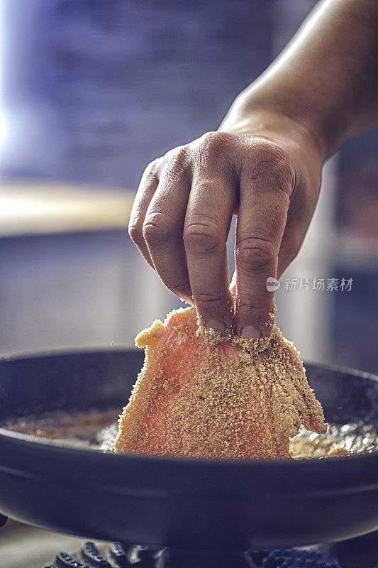 用平底锅在深油中煎炸维也纳炸肉排