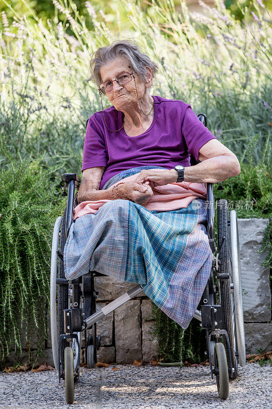 截肢妇女坐在户外轮椅上的肖像