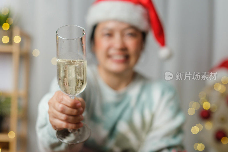 亚洲妇女举杯庆祝新年和圣诞派对视频打电话回家的朋友