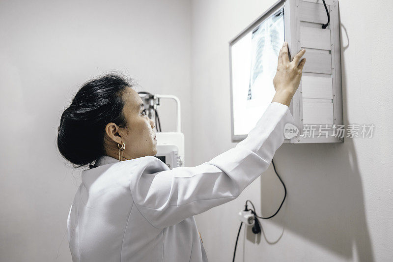 女医生在实验室分析肺部x光片