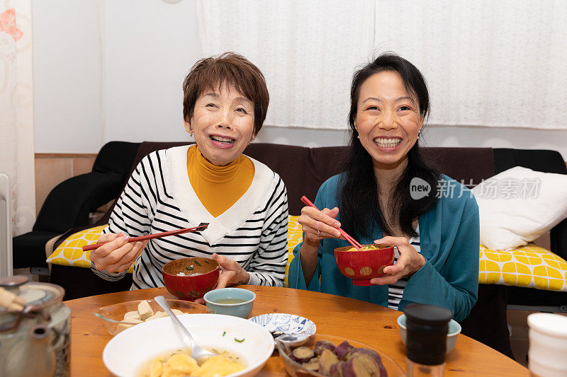 母亲和女儿正在享用晚餐