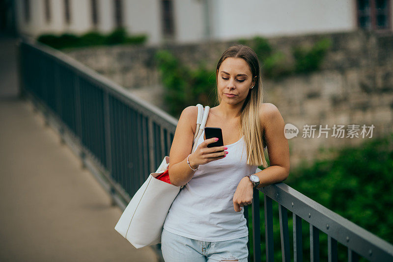 在城市里使用智能手机的女人