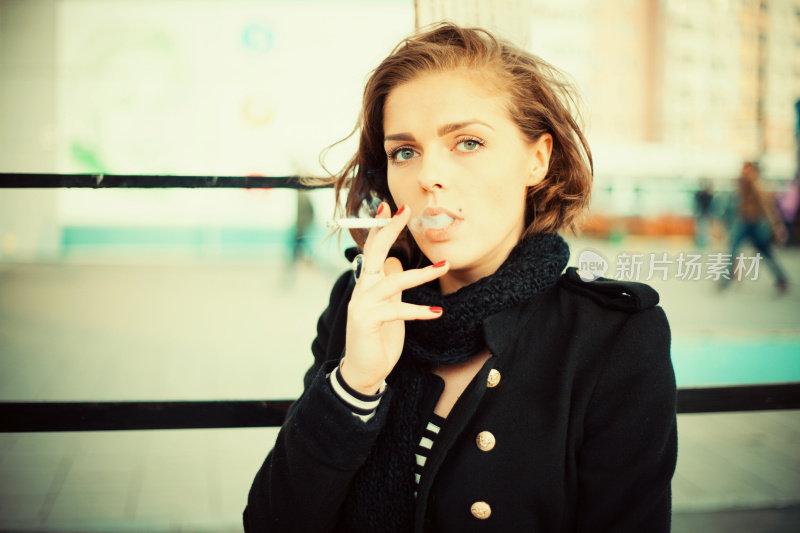 沉思的女人在街上抽烟