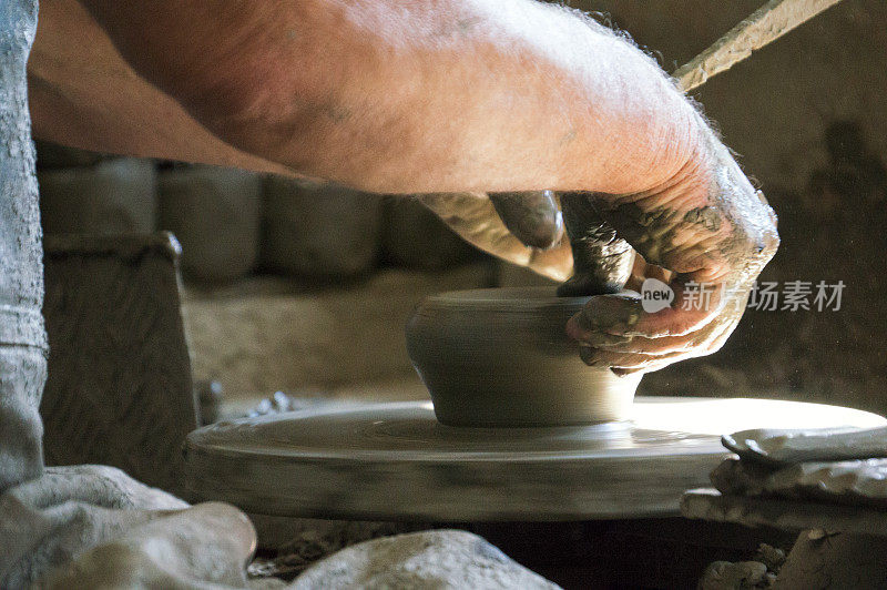 陶工在陶轮上塑造粘土。