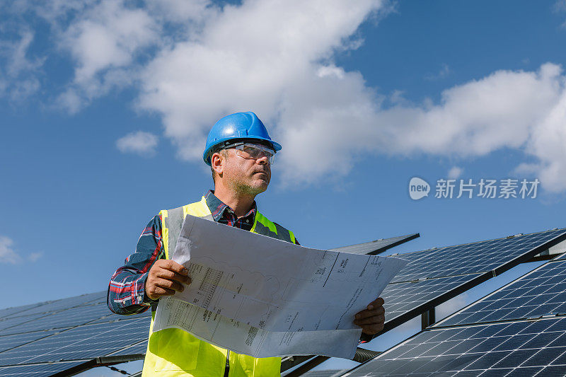 太阳能农场工程师回顾蓝图:绿色能源发电的太阳能电池板的规划和安装