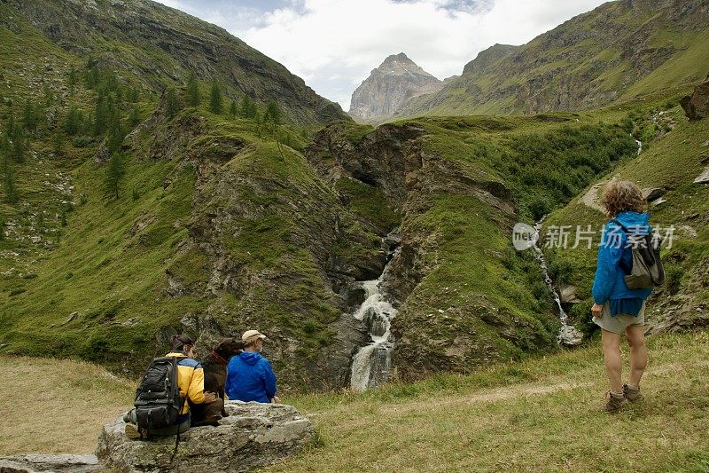 一家人带着狗欣赏意大利阿尔卑斯山的景色