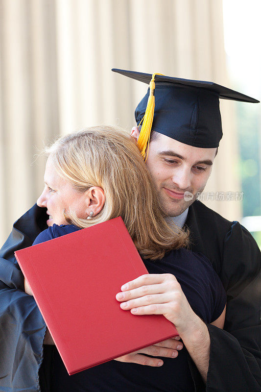 母亲在毕业典礼上拥抱毕业儿子横
