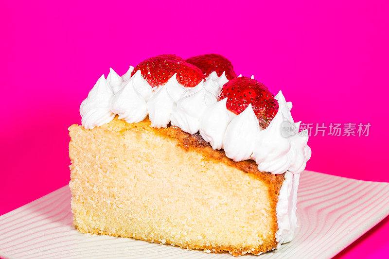 一份香草蛋糕，在洋红色的表面涂上草莓和奶油