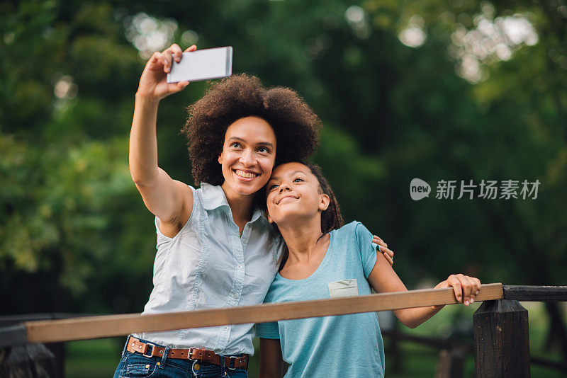 微笑的女人和她的女儿在一起自拍