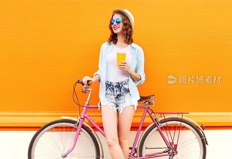 有咖啡或果汁杯和复古自行车的时尚女性