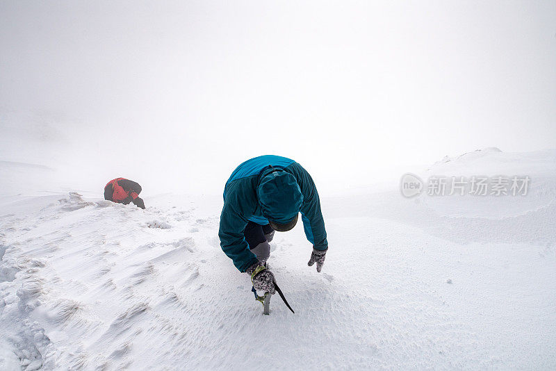 两个人走在雪山的山峰上进入云中