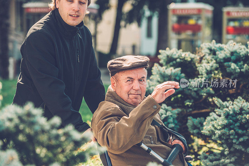 轮椅老人问候，孙子协助，城市，欧洲