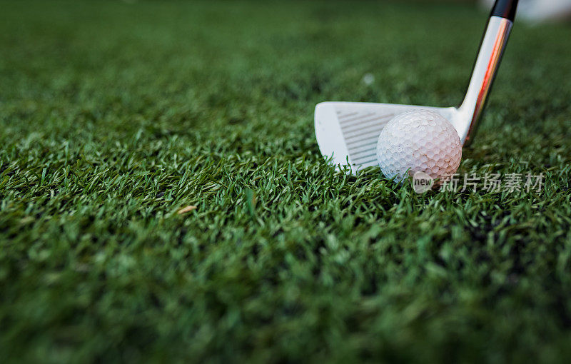 高尔夫球棍和球在绿色草地上