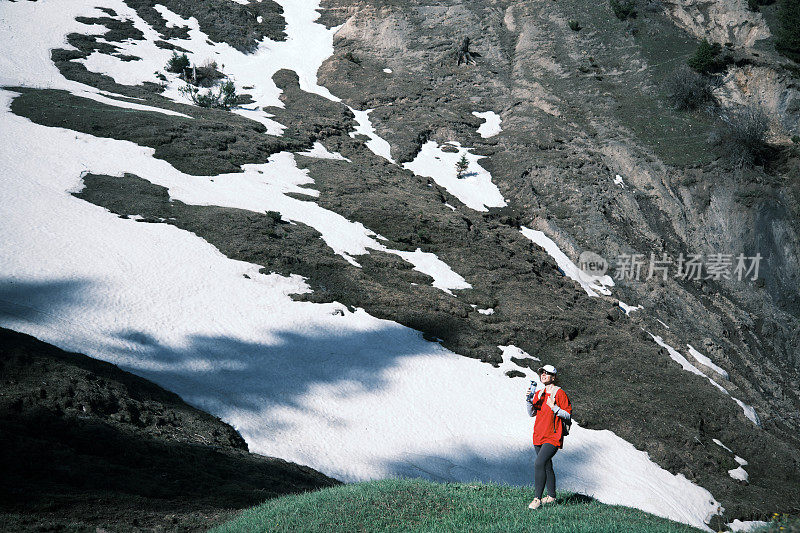 女徒步旅行者正在山里喝水