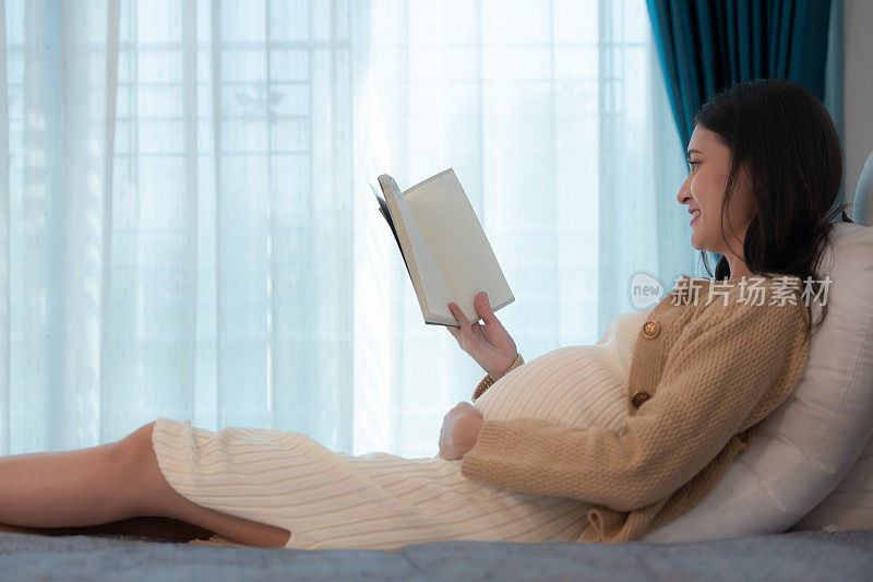 一位孕妇正在给她未出生的孩子读故事