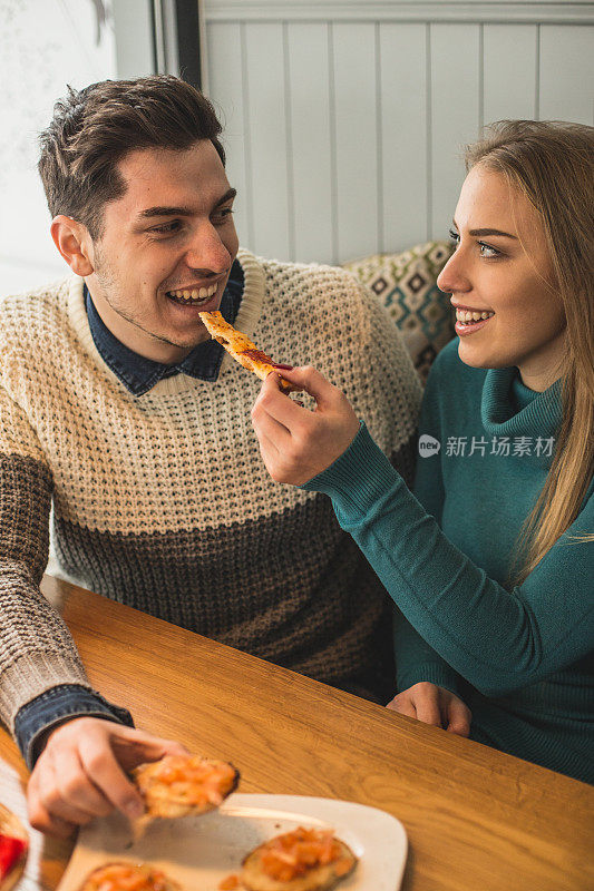 夫妇在咖啡馆酒吧分享食物