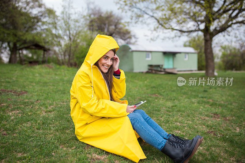 穿着雨衣坐在田野上听音乐