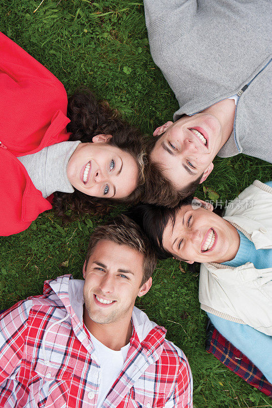 四个朋友躺在草地上
