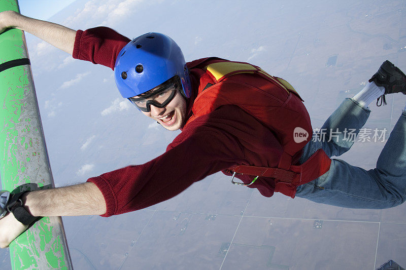 版权免费股票照片:跳伞者悬挂在飞机支柱