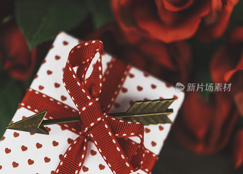 情人节的玫瑰花束和用丘比特的箭装饰的礼物