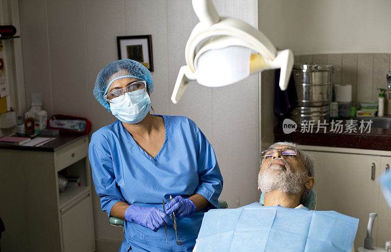 牙医在诊所给老人做手术