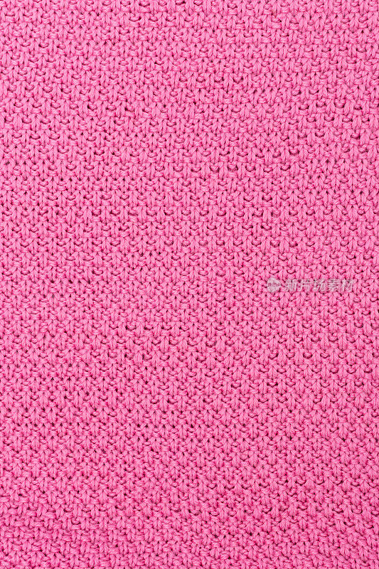 粉红色针织面料珍珠羊毛背景。织物的结构具有自然的纹理。织物的背景。针织羊毛背景。