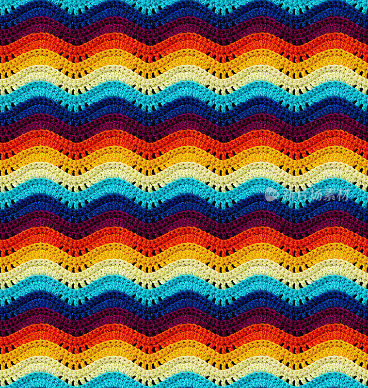 无缝编织的图案在开放的波浪形式是钩针与明亮的色彩线。棉纱。