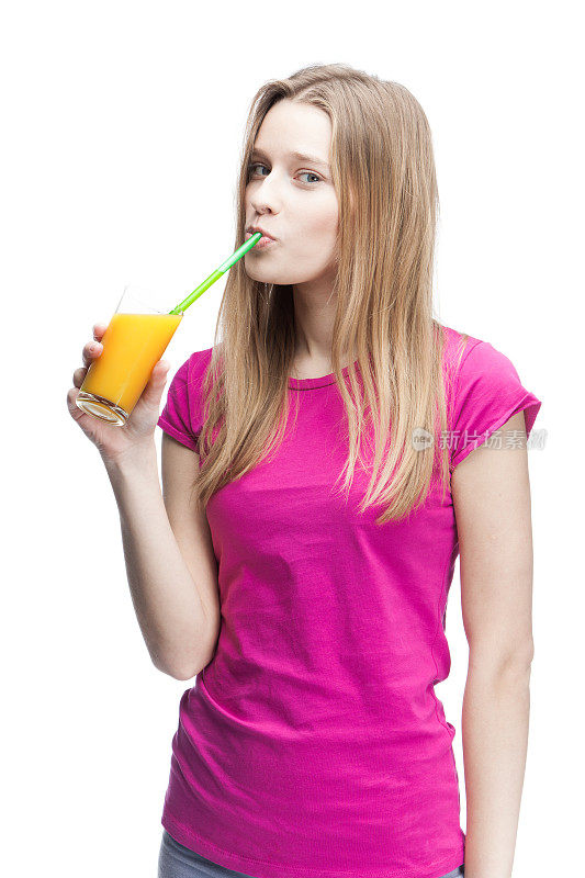 年轻漂亮的金发女人喝着橙汁