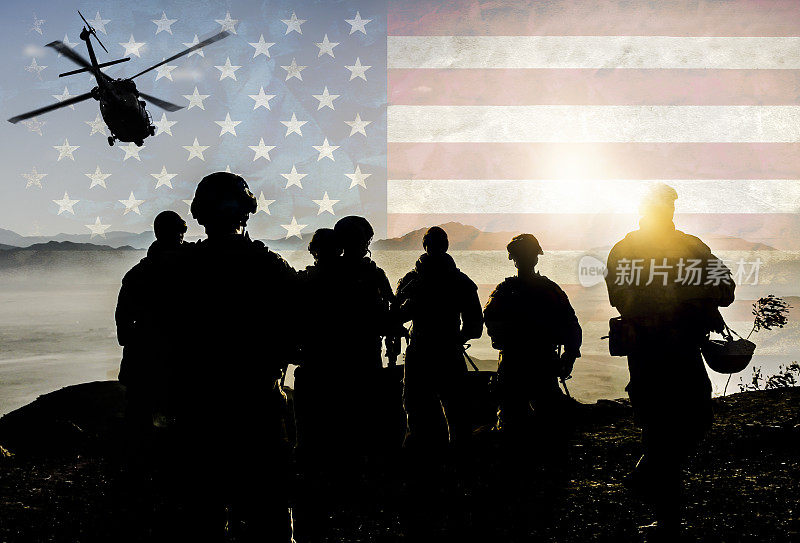 在美国国旗背景下执行军事任务的士兵剪影
