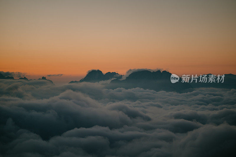 在白色的云海之上，有陡峭的悬崖和山峰的宁静景色。特伦蒂诺山谷绝佳的旅游景点