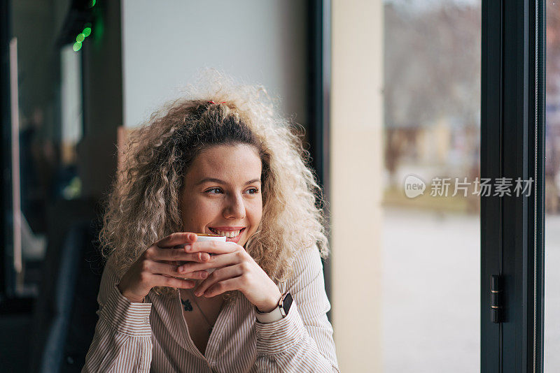 年轻女子正在享用她的咖啡