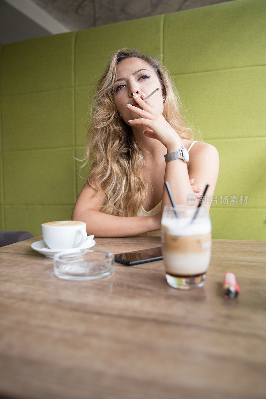 在咖啡店抽烟的漂亮女人