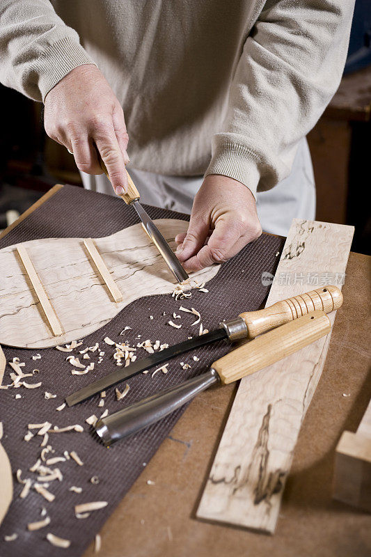 工匠的手在作坊雕刻小提琴