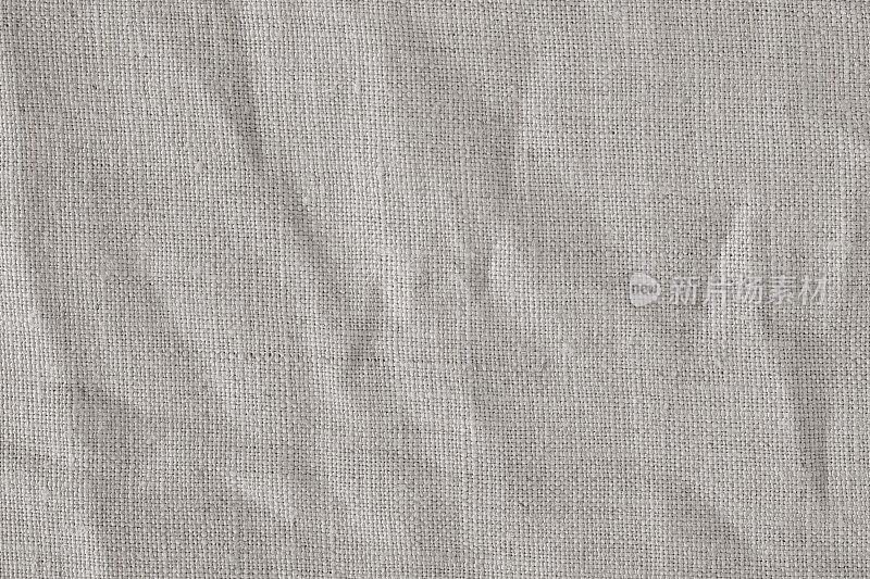 褶皱米色棉麻织物纹理背景，细节特写，质朴皱皱的复古织物。