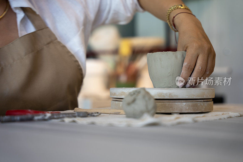 在手工陶瓷作坊将陶土塑造成杯子的过程，在陶瓷作坊里塑造陶瓷