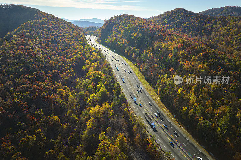 鸟瞰图:金秋时节，北卡罗莱纳州I-40高速公路穿过阿巴拉契亚山脉，通往阿什维尔，沿途有卡车和汽车在移动。州际运输概念