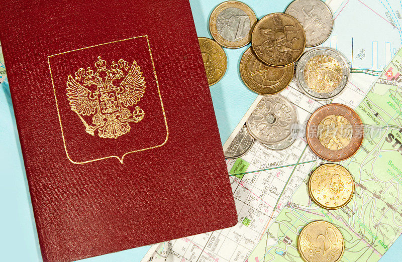 布兰克护照和许多硬币在不同的地图上