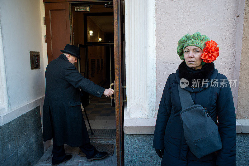 一个女人和一个男人站在莫斯科阿尔巴特街一所房子的入口处。