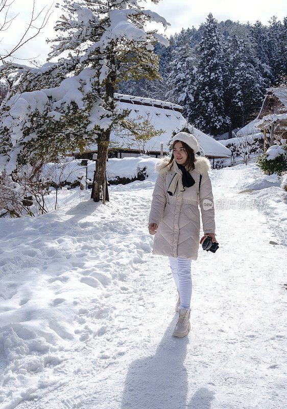 美丽的女子游客享受他们的日本之旅在雪的冬天