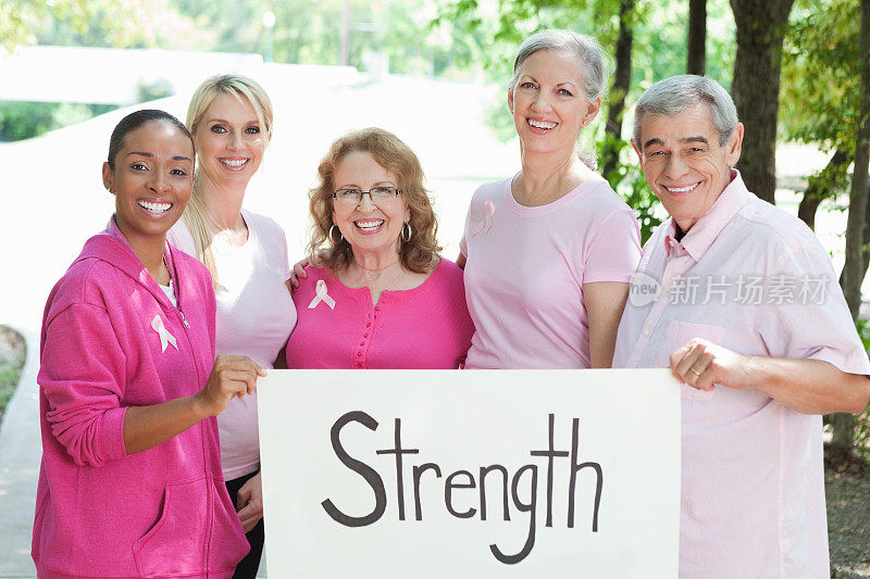 不同群体的乳腺癌幸存者和支持者举着“力量:”的牌子