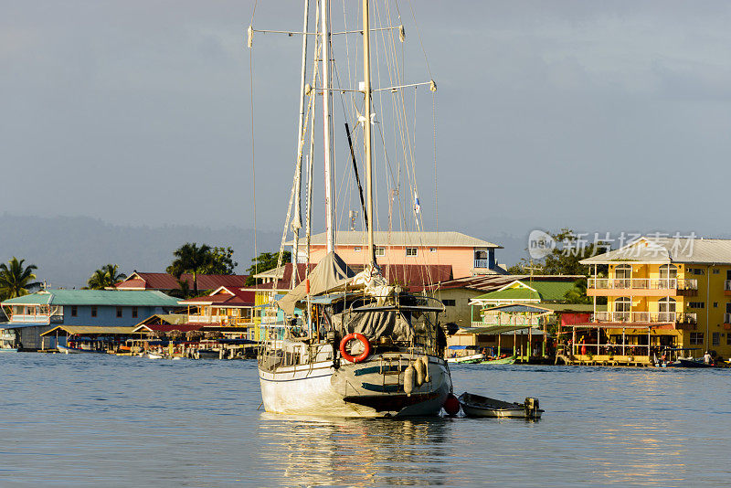 帆船在五彩缤纷的海滨小镇前。