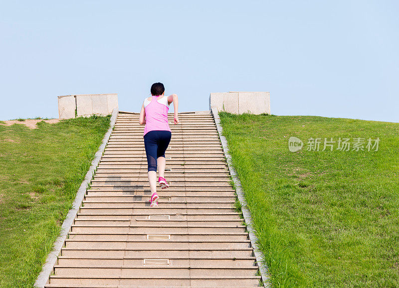 年轻女子在石阶前奔跑