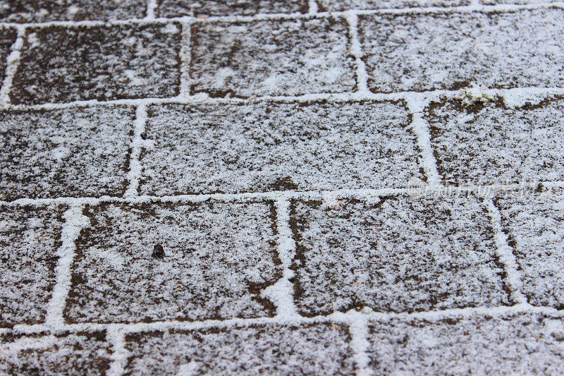 在寒冷的冬天，砖铺被雪覆盖的图像