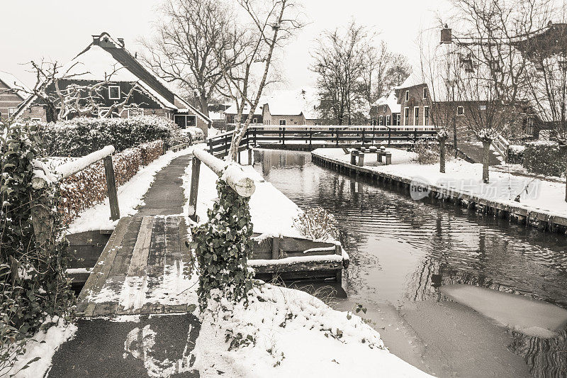 在一个寒冷但美丽而平静的冬天，Giethoorn村附近的Dwarsgracht有积雪的运河