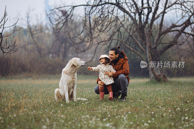 年轻的父亲和他的女儿和一只狗