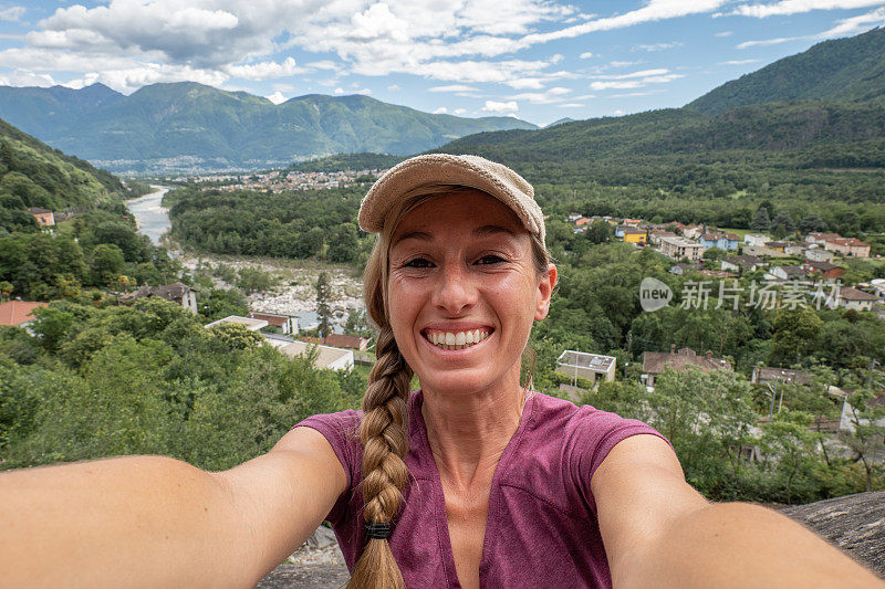 一名女登山者在岩石上自拍