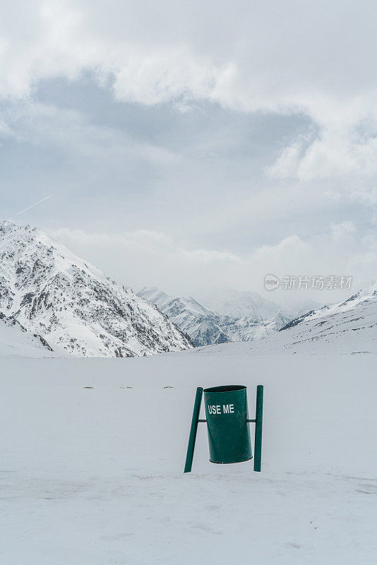 喀喇昆仑公路雪山背景上的垃圾桶