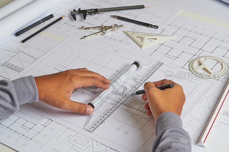 建筑师、工程师、承包商在建筑师工作室设计施工图、草图、平面图、制作建筑施工房屋。